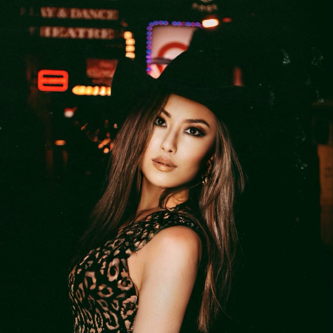 Portrait of Yoko J. Bian against neon signs